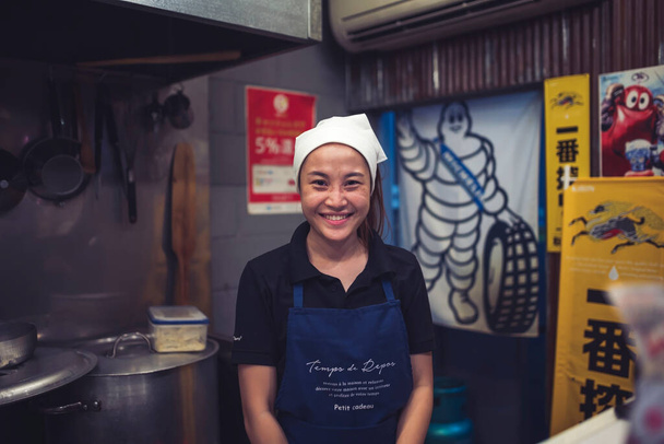 Chiang mai, Thailand - April 6, 2022: Chef, owner of a Japanese restaurant A black shirt, a blue apron, a white turban draped over his head in his kitchen. - Foto, Imagem