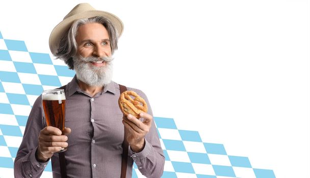 Senior man in traditional German clothes, with beer and pretzel on white background. Octoberfest celebration - Foto, Imagen