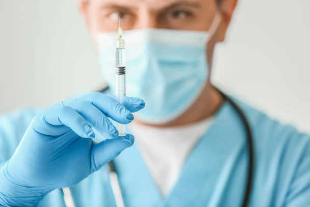 Male doctor with syringe in clinic, closeup - Zdjęcie, obraz