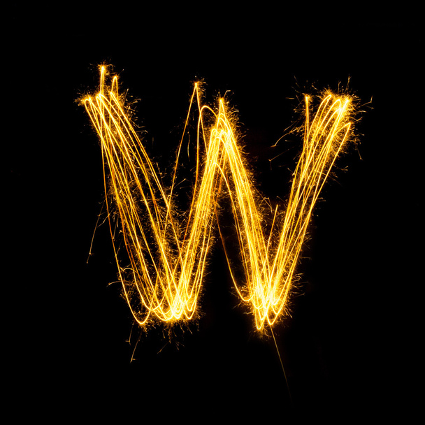 Sparkler firework light alphabet W. - Foto, Imagen