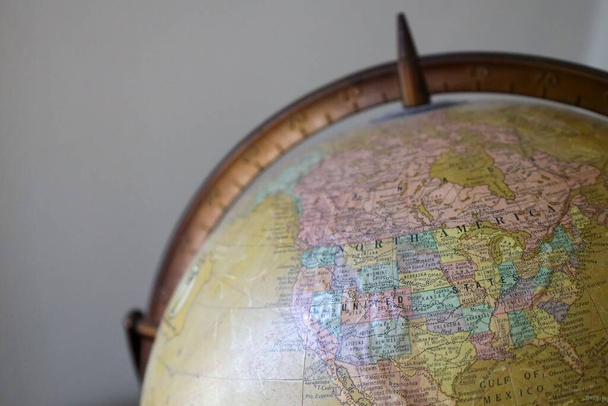 A close-up shot of an ancient globe with the section of North America - 写真・画像