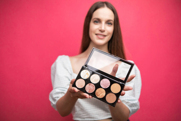 Woman hold make up pallete in the hands. . High quality photo - Fotó, kép