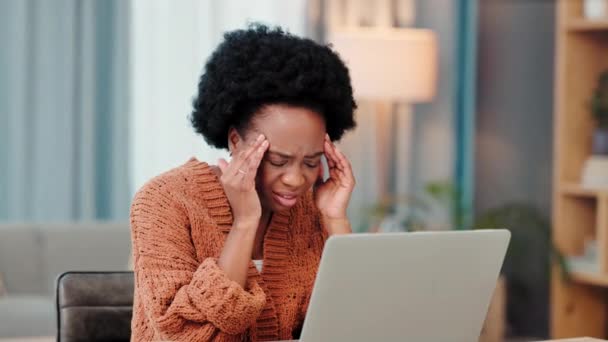 Frustrated, irritated and annoyed woman with a headache or migraine experiencing anxiety, worry or stress. Young female working on her laptop and feeling upset or negative about a failed task. - Footage, Video