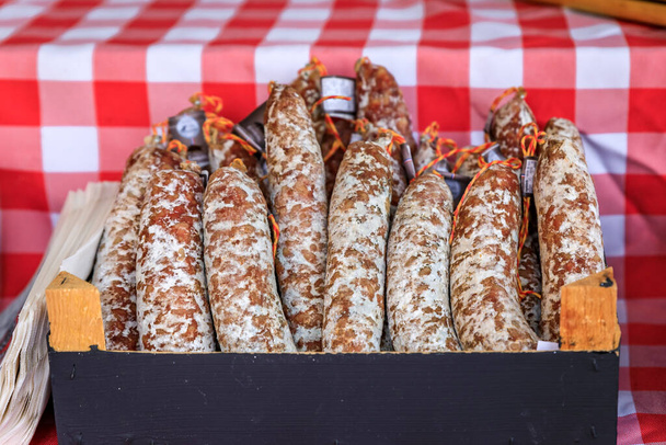 Artisanal sausage in a box on a stand at a local farmers market Cours Saleya in Old Town, Vieille Ville in Nice, French Riviera, France - 写真・画像