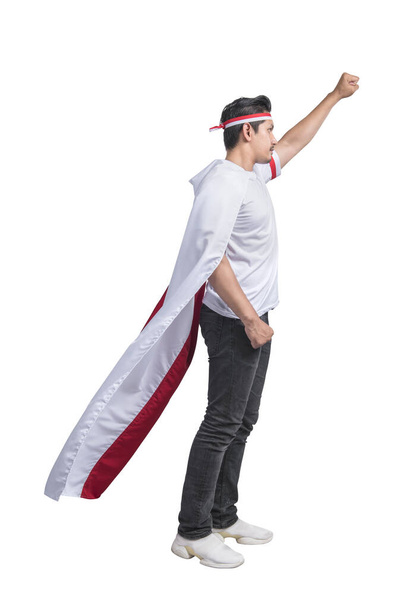 Indonesian men celebrate Indonesian independence day on 17 August by wearing the Indonesian flag isolated over white background - Zdjęcie, obraz