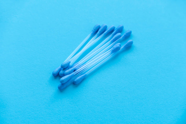 A cotton buds on blue background. - Foto, immagini