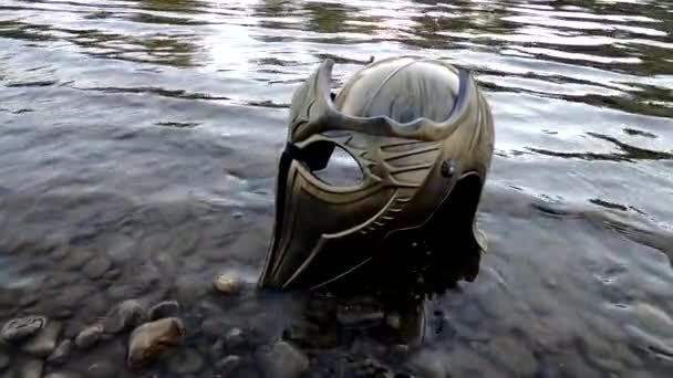 Metaphorical installation on a mountain river with a gladiatorial helmet - 映像、動画