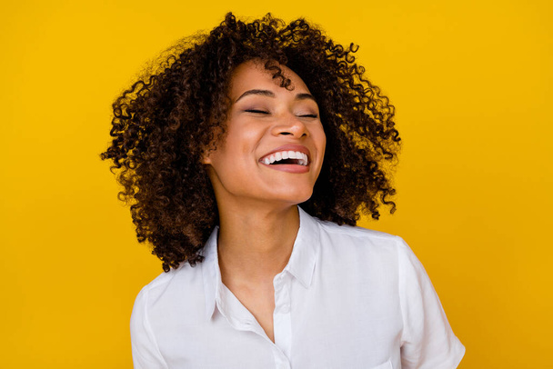 Photo of adorable gorgeous nice girl with wavy hairdo dressed white blouse toothy laughing eyes closed isolated on yellow color background. - Photo, Image