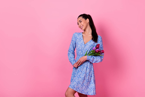 Photo of lovely brunette young lady hold bouquet wear blue dress isolated on pink background. - Foto, Imagen