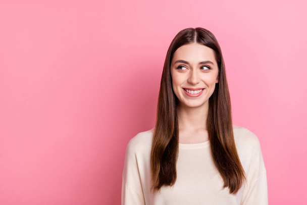 Portrait of attractive cheerful brunet girl looking aside copy space isolated over pink pastel color background. - Fotografie, Obrázek