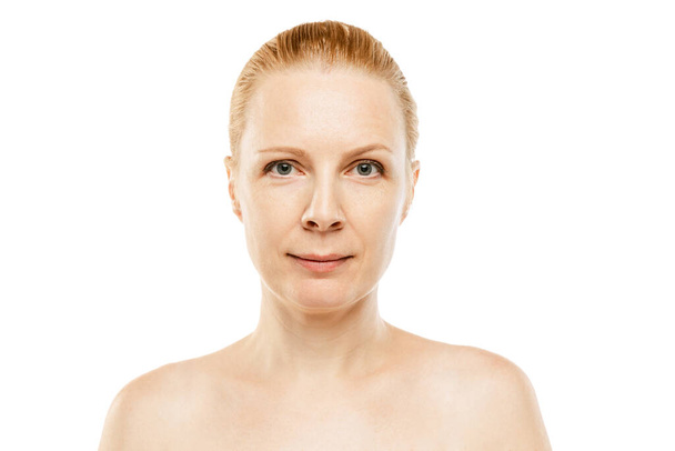 Portrait of beautiful middle-aged woman with blonde hair isolated over white background. Looking at camera. Face lifting cosmetology treatment. Concept of beauty, spa, age-related changes, skin care - 写真・画像