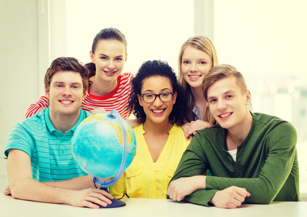 five smiling student with earth globe at school - Zdjęcie, obraz
