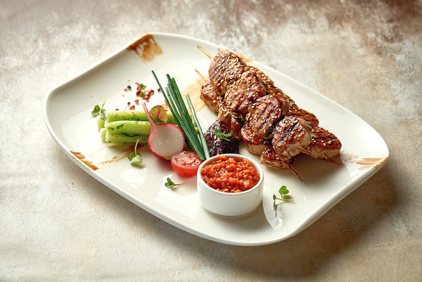 Pork shish kebab with salad and sauce. Close-up selective focus. Grilled meat - Foto, Imagem