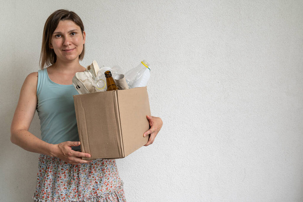 Female holding box of recycling materials, copy space - Foto, Imagen