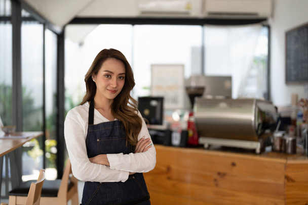 Coffee Business owner Concept - attractive young beautiful asian barista with apron in coffee shop counter - Photo, Image