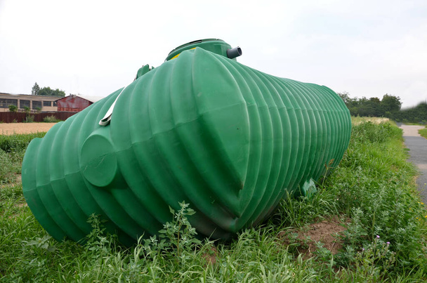 green plastic retention tank, rainwater tank with round neck and honeycomb ribbing. rainwater is purified, sedimented and stored, watered, is intended to be buried under the top of the terrain - Valokuva, kuva