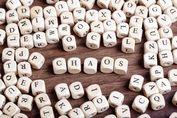 Word Chaos in letters on cube dices on table. - Foto, Imagem