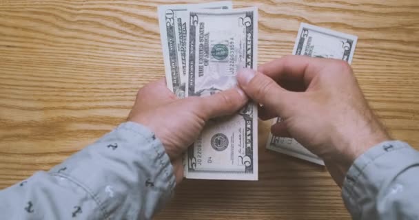Mens hands count money, cash American dollars. Top view from the first person. Concept of getting a salary, credit, work, taxes, finance, payment for services, high price. High quality 4k footage - Felvétel, videó