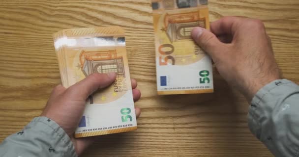 Mens hands count money, cash euro. Top view from the first person. Concept of getting a salary, credit, work, taxes, finance, payment for services, high price. High quality 4k footage - Materiaali, video