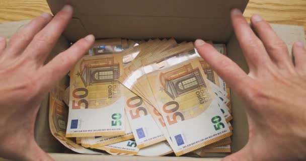 male hands open cardboard box full of euro cash. Top view, close-up. Concept of hidden money, inheritance, gift, shadow economy. High quality 4k footage - Πλάνα, βίντεο
