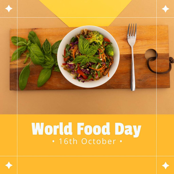 Image of world food day over orange background with bowl of salad. Food, nutrition and food production concept. - Fotografie, Obrázek
