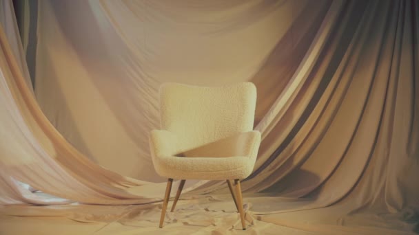 Pillow falls on a white chair. - Video
