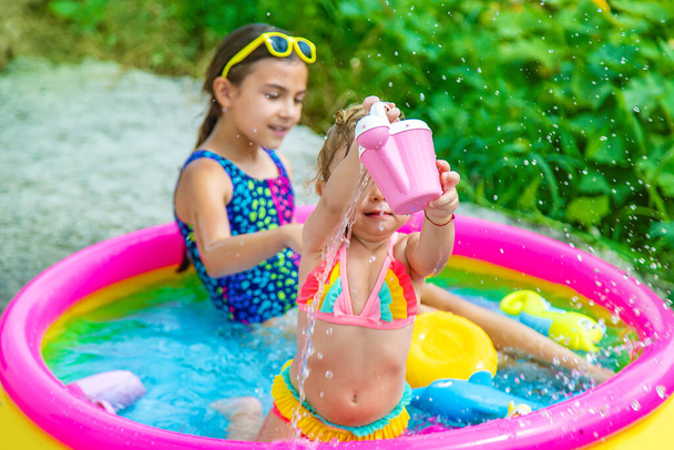 Children swim in the pool. Selective focus. Kid. - Фото, изображение