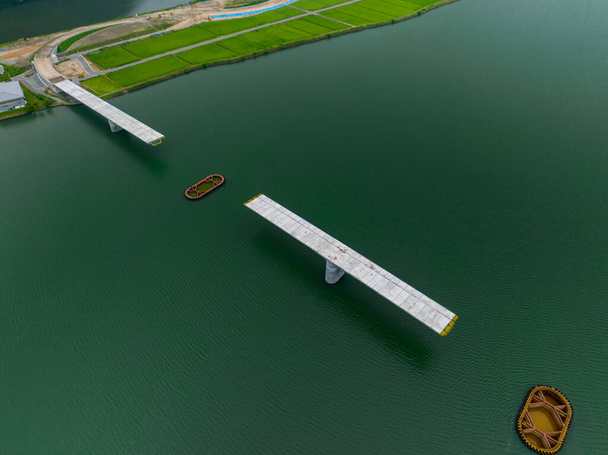 Overhead view of unfinished bridge and pylon foundations in river. High quality photo - Photo, image