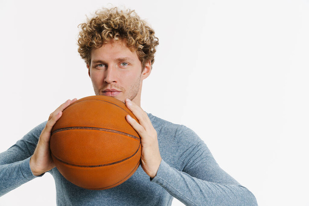 Young bristle man in sportswear posing with basketball isolated over white wall - Φωτογραφία, εικόνα