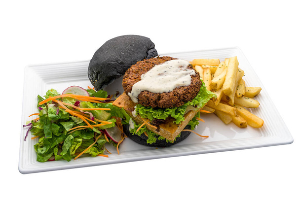 Double patty burger with Quinoa Tofu and Nyonya Otah, fries and salad served in dish isolated on plain white background side view of fastfood - Foto, Imagen