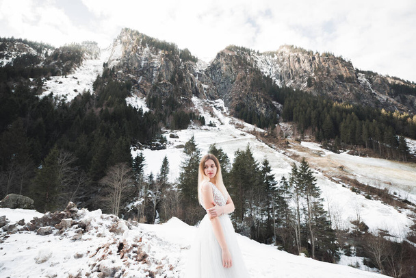 Beauty woman, bride with perfect white dress background mountains. - Фото, изображение