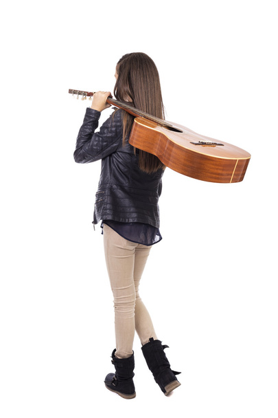 Full length portrait of  girl with a guitar on her shoulder, bac - Foto, Imagem