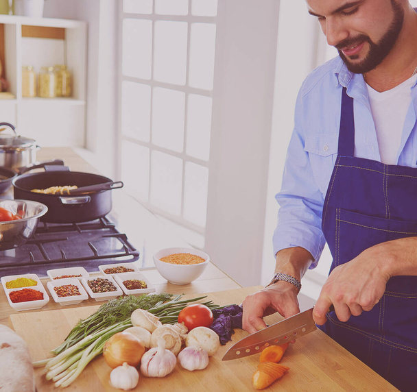 Man preparing delicious and healthy food in the home kitchen. - Photo, Image