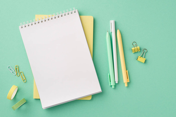 Back to school concept. Top view photo of stationery open planer pens binder clips and adhesive tape on isolated pastel green background with blank space - Foto, Imagen