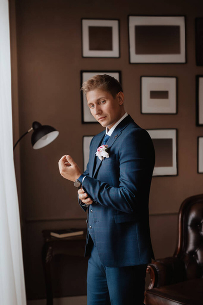 Portrait of beautiful young groom. Happy man in a suit on his wedding day. Wedding day concept - Fotografie, Obrázek