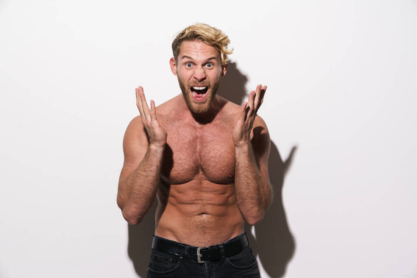 Shirtless blonde man screaming while gesturing at camera isolated over white background - Φωτογραφία, εικόνα