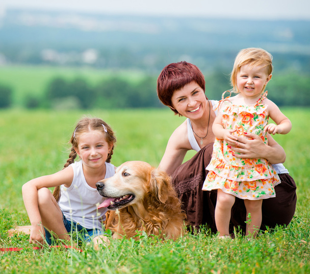 Family with a golden retriever dog - Fotoğraf, Görsel