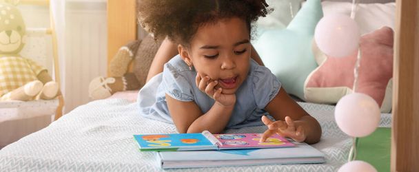 African American girl reading book at home. Banner design - Фото, изображение