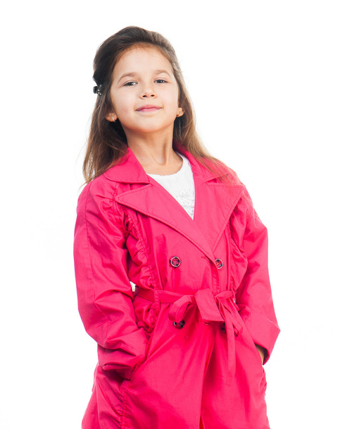little girl in a pink raincoat - 写真・画像