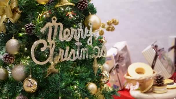 Merry Christmas decoration with blinking led light at tree beside bokeh bakery - Filmati, video