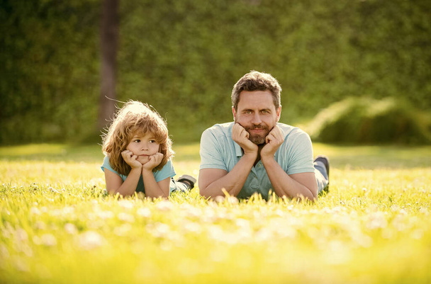 happy family of daddy and son child relax in summer park green grass, fatherhood. - Foto, imagen
