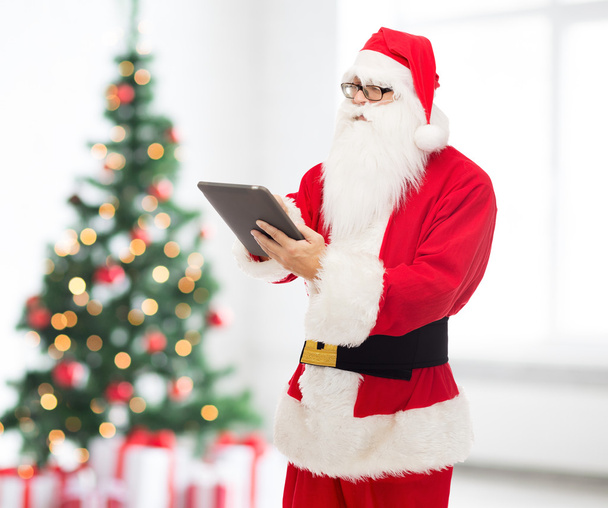 man in costume of santa claus with tablet pc - Photo, image