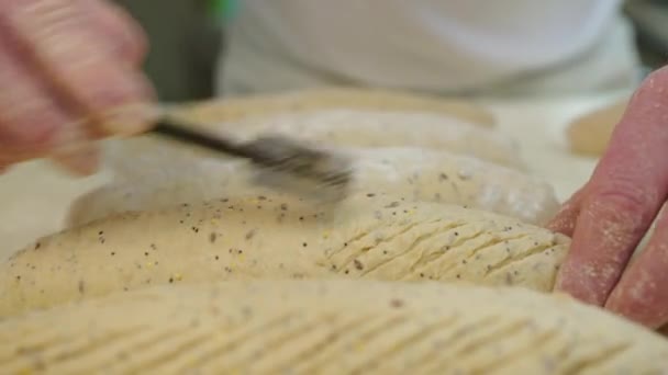 Kneading Dough. Baker preparing the dough for bread. Manufacture of bakery products. The baker is making dough products. High quality 4k footage - Materiał filmowy, wideo