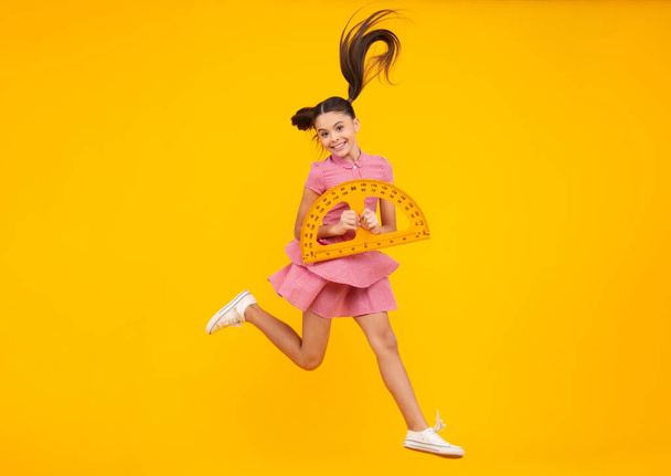 Back to school. Teenager school girl on isolated background. School supplies. Crazy jump, jumping kids. Happy teenager, positive and smiling emotions of teen schoolgirl - Photo, Image