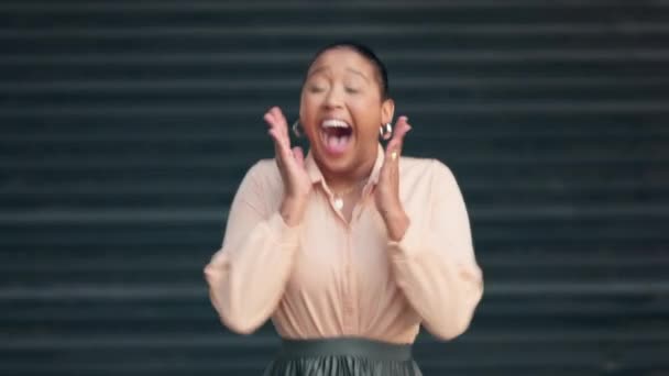 Shocked, surprised and excited female celebrating good news against dark background. Black woman expressing surprise with an open mouth and omg gesture, thrilled with a promotion or positive result. - Video
