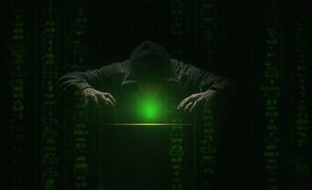hacker přes obrazovku se zeleným binárním kódem. Kriminalita a krádež informací a počítačů - Fotografie, Obrázek