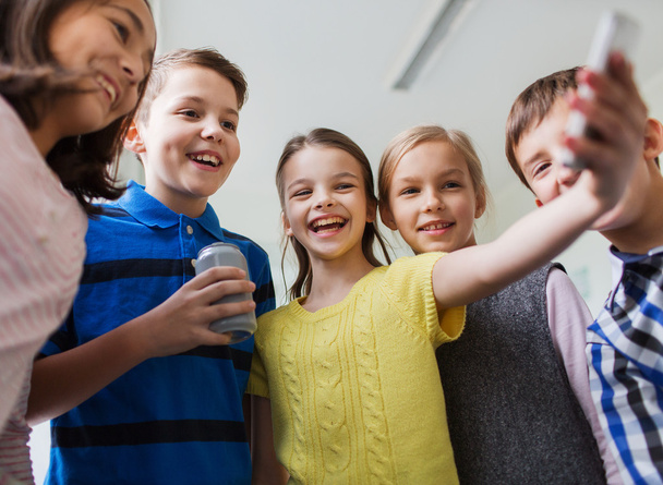 group of school kids with smartphone and soda can - Photo, image