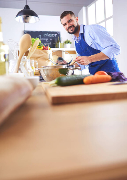 Man preparing delicious and healthy food in the home kitchen. - Photo, Image