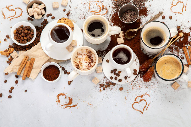 Coffee cup assortment on light background. Modern breakfast concept. Top view, flat lay, copy space - Фото, зображення