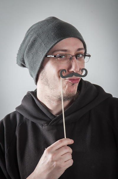 Αστείος άνθρωπος παίζει με Τιμονιού μουστάκι - Φωτογραφία, εικόνα